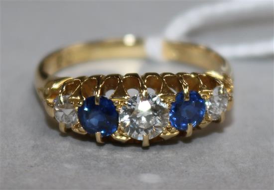 An early 20th century 18ct gold and graduated five stone sapphire and diamond ring, size R.